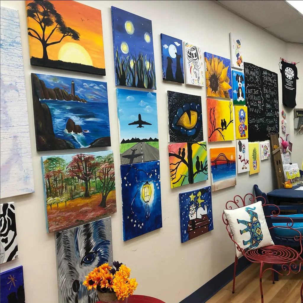 Student paintings of sunsets, night skies and animals hung gallery-style