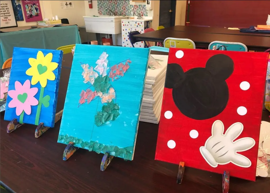 Three finished kids' canvases: a flower, a bouquet and a cartoon mouse