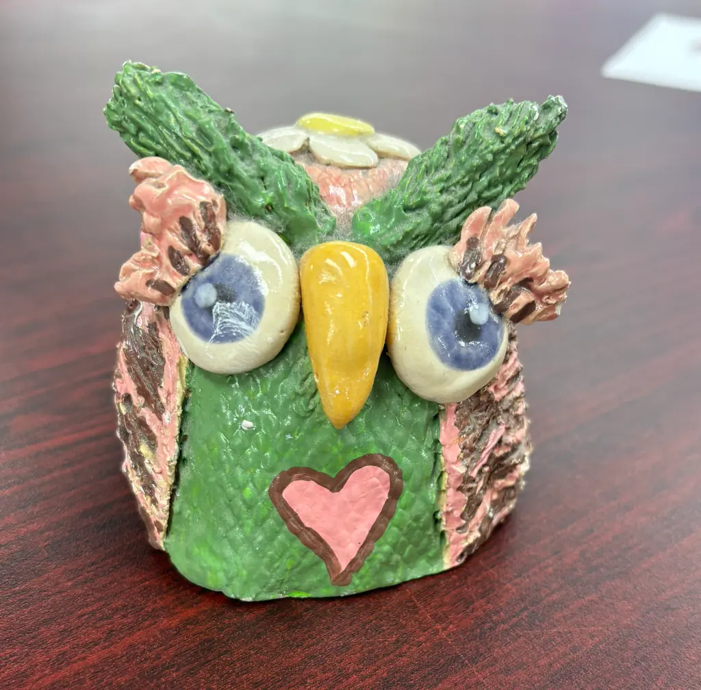 A painted clay owl sculpture made in class