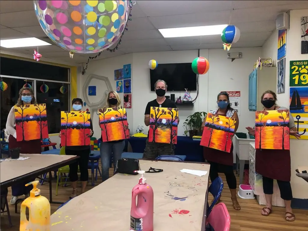 Kids showing off tie-dye shirts at a party